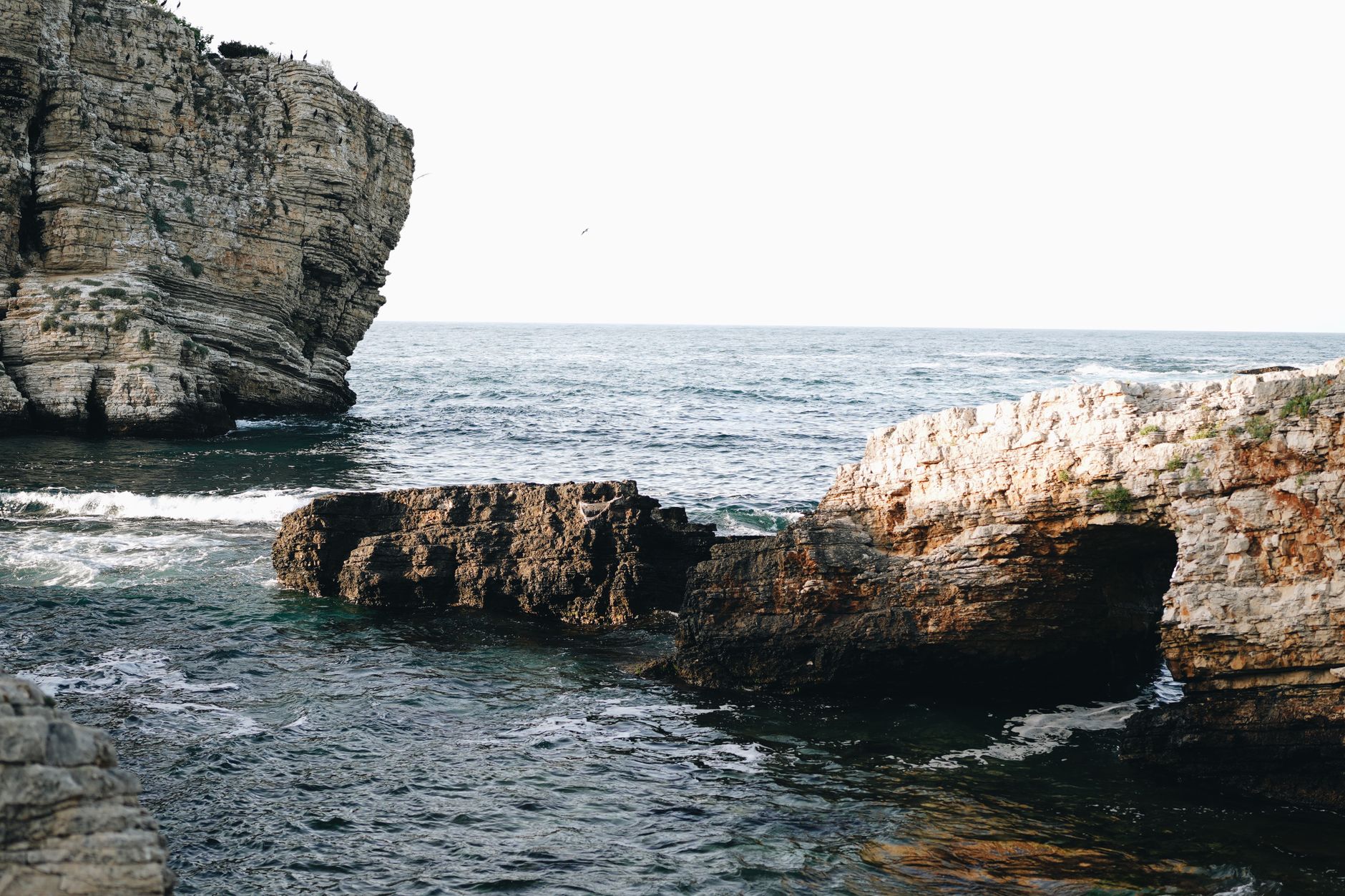 Sunlit Mediterranean cove with turquoise water