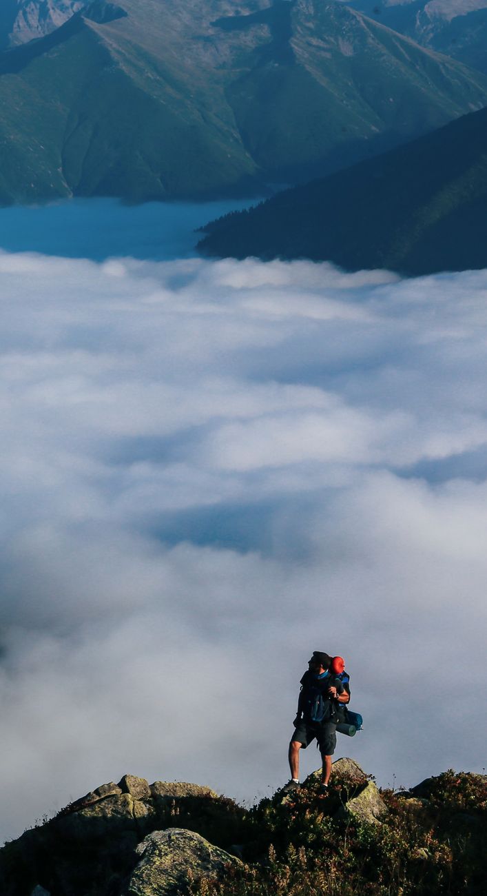 Hiker looking across an expansive mountain ridge